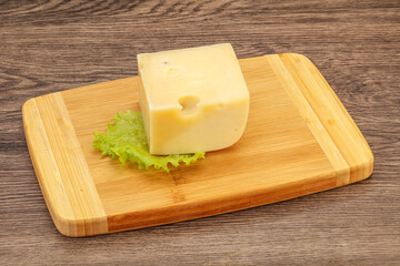 Emmental cheese over wooden board