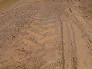 The mark of heavy vehicle tires that have gone through a muddy soil. 
