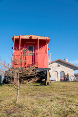A caboose from the former Grand Trunk Railway sits on display at the old railway train station in St. Mary's, Ontario on a beautiful sunny autumn day.