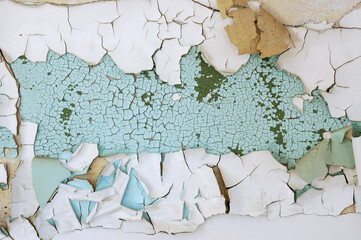 Cracked wall with flaking turquoise paint