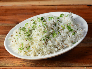 Cumin rice or Jeera Rice is a popular Indian main course item made using Basmati rice flavored with fried cumin seeds and basic spices, selective focus