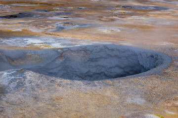 A hole with boiliing mud in Hverir Geothermal Area close to Reykjahlid town in Iceland