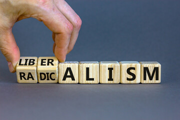 Radicalism or liberalism symbol. Male hand turns cubes and changes the word 'radicalism' to...