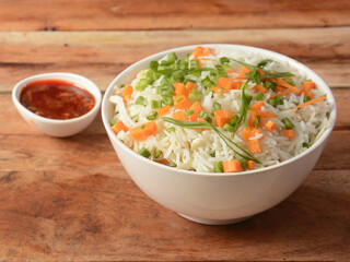 Healthy and tasty veg fried rice made of mixed veggies served in bowl over a rustic wooden background, Indo chinese, Indian cuisine, selective focus