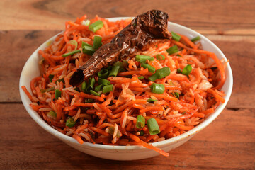 Tasty veg schezwan fried rice served in bowl over a rustic wooden background, Indian cuisine, selective focus