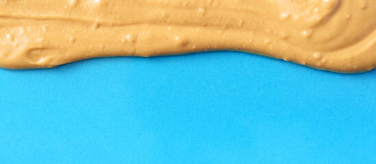 Nut butter melted on the blue background.