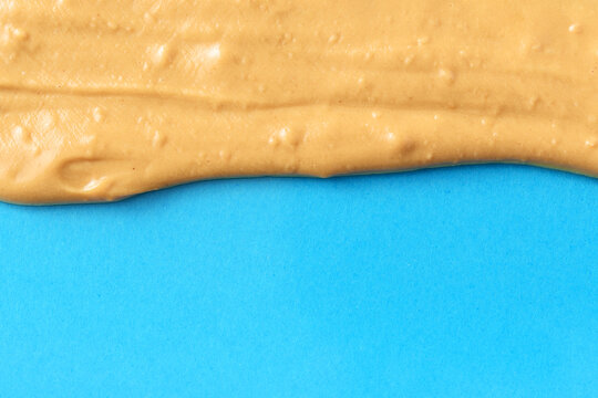 Nut butter melted on the blue background.