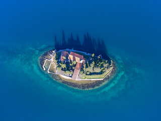 Top view from a drone on an island with a monastery in the Adriatic sea. Isle Saint George