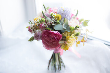 Amazing spring flower bouquet with garden roses, Veronica, craspedia, waxflower, carnations and eucalyptus