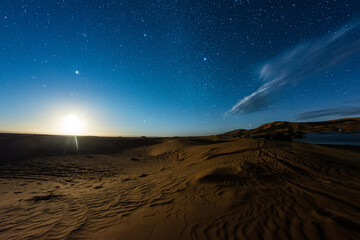 Fototapeta na wymiar moon rising in the desert
