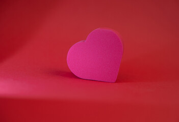 Red heart on red background with light effects