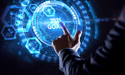 Business, Technology, Internet and network concept. Young businessman working on a virtual screen of the future and sees the inscription: 2021 goals