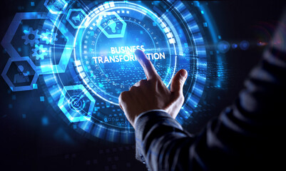 Fototapeta premium The concept of business, technology, the Internet and the network. A young entrepreneur working on a virtual screen of the future and sees the inscription: Business transformation