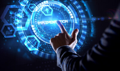 Business, Technology, Internet and network concept. Young businessman working on a virtual screen of the future and sees the inscription: Implementation