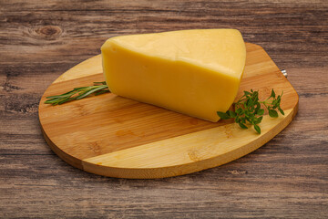 Hard cheese piece served rosemary