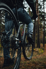 Close view on rear wheel of a mountain bike, bicycle's gear set, active life in forest