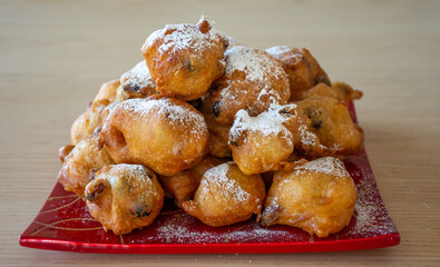 Pile of delicious 'oliebollen' : (deep-fried raisin buns) with powdered sugar: a Dutch traditional delicacy