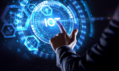 Internet of things - IOT concept. Businessman offer IOT products and solutions. Young businessman  select the abstract chip with text IoT on the virtual display