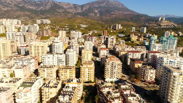 Flying copter over beautiful Mahmutlar town in Taurus Mountains. Antalya Province in Turkey. Slow motion, 4k.