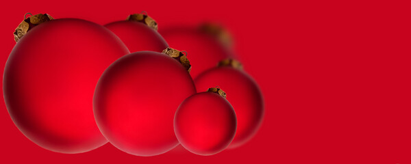 Christmas banner. Red balls on a red background. Christmas, holiday, greetings. Background for advertising and business.