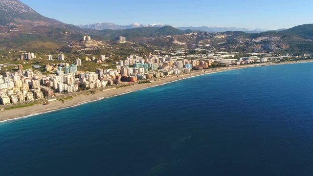 Footage panorama of flying drone over Mediterranean sea overwashing beautiful town Mahmutlar and Taurus Mountains in Antalya Province, Turkey.