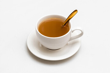 White cup of tea and herbal beverage, Top view, golden spoon, isolated white background