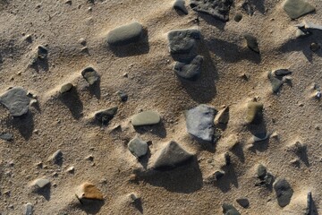 Fototapeta na wymiar rocks on beach sand