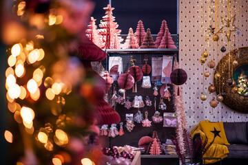 Colorful Christmas decor at the Maastricht Christmas Market. Gifts, fir tree branches, decorations and blurred glow of garlands. Christmas, winter, new year concept.