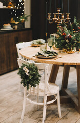 Festive Christmas table decorations. Christmas dining room. Beautiful New Year decorated home interior.
