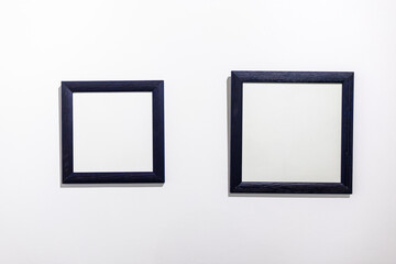 Blank photo frames on white wall in the exhibition room