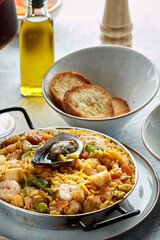 Classic valencian paella from rice with seafood and vegetables - traditional dish of spanish cuisine and sangría