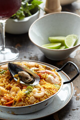 Classic valencian paella from rice with seafood and vegetables - traditional dish of spanish cuisine and sangría