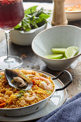 Classic valencian paella from rice with seafood and vegetables - traditional dish of spanish cuisine and sangría