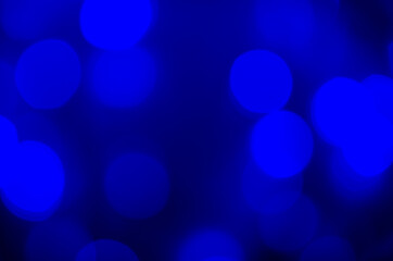 Abstract pattern of blue bokeh lights on a dark background