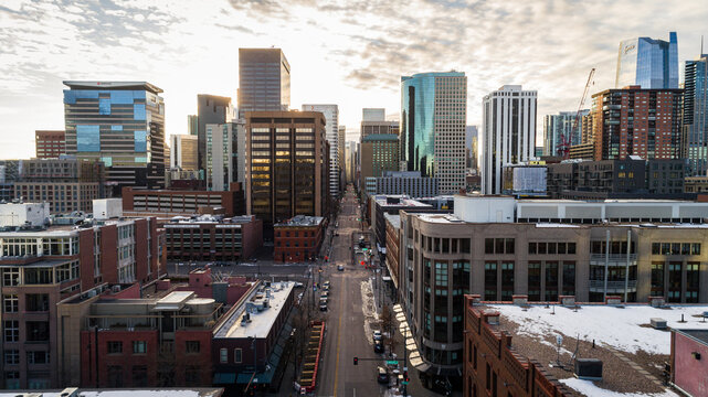 "Denver, CO USA - 11-29-2020: Epic drone shot leading through the heart of downtown Denver on 17th st."