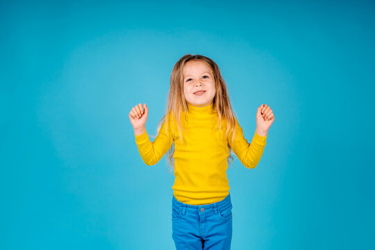 happy little girl isolated on blue background