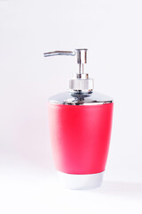 Obraz premium Red plastic and metal bottle packing of sanitizer, antiseptic with dispenser for hygienic, fluid, cosmetic, liquid, sanitary soap, gel and detergent isolated on white background. Soap Pump Bottle.