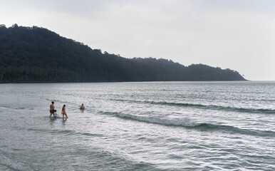 People bathing on the beach of the coconut island