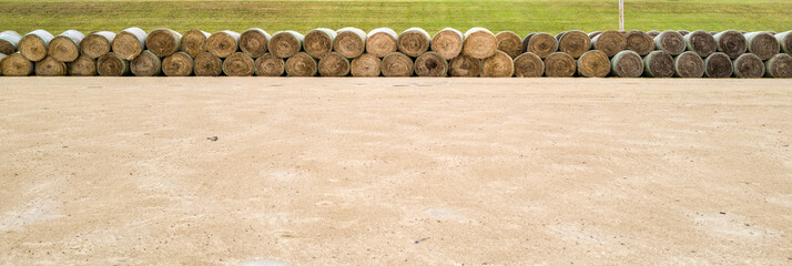 Hay Bales rolled up on the farm field - Powered by Adobe