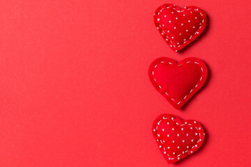 Fototapeta premium Top view of textile hearts on colorful background. Valentine's day concept with copy space