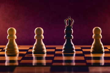 Black pawn in crown among white pawns on chess board. Personal Growth and Development concept