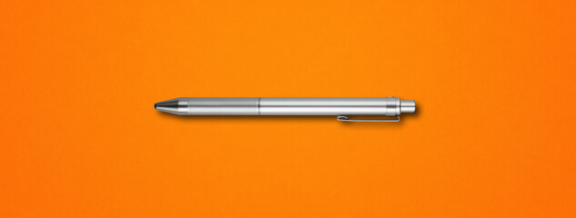 Metal pen isolated on orange background
