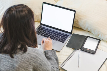 woman working studying on laptop laying in bed top view