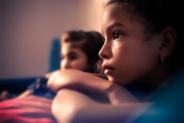 Portrait of two small girls watching TV - 397065427