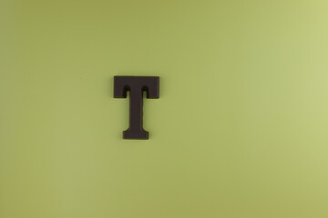 Fototapeta premium The letter of the alphabet T is made from milk chocolate