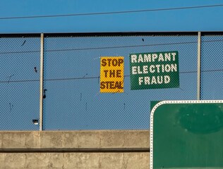 Homemade signs on a freeway overpass alleging fraud in the 2020 united states presidential election