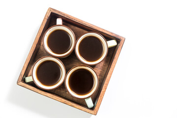 Mango wood wooden tray with four espresso coffee cups. Empty space