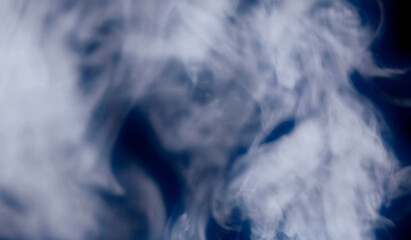 An abstract big smoke background, steam shapes with a blue glow. Studio shot. Add to your existing footage via overlay or screen channel.
