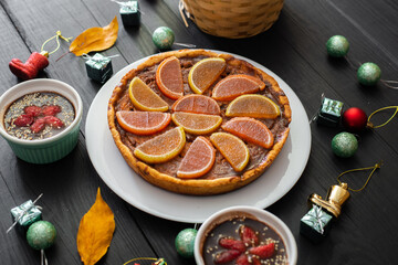 Pumpkin pie, sweet desserts and Christmas toys on a black background.