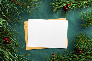 Christmas greeting card mockup with pine tree branches on green background